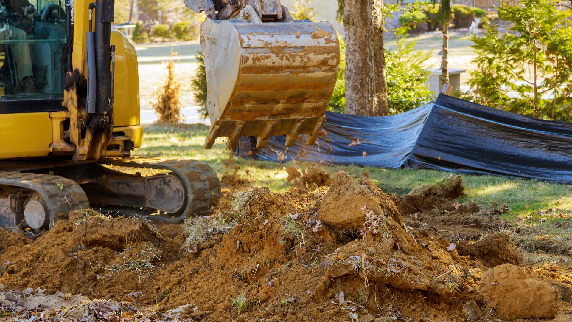 A bulldozer digging through a pile of dirt